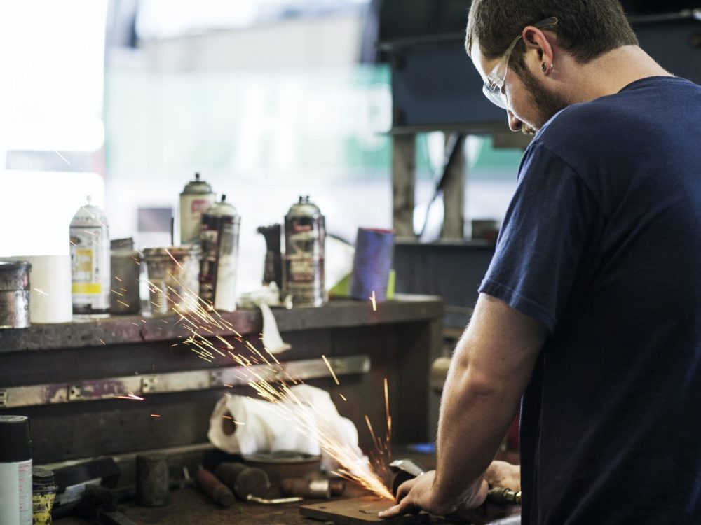 Mechanic Grinding Metal In Workshop Mechanic Grinding Metal In Workshop